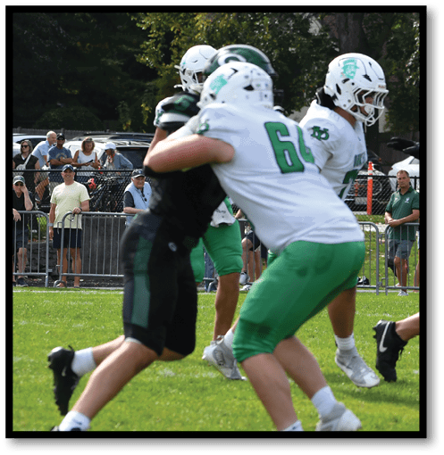 A group of men wearing black and white jerseys. Description generated by AI