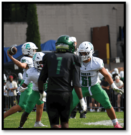 Two football players wearing black jerseys with the number 11 on them. Description generated by AI