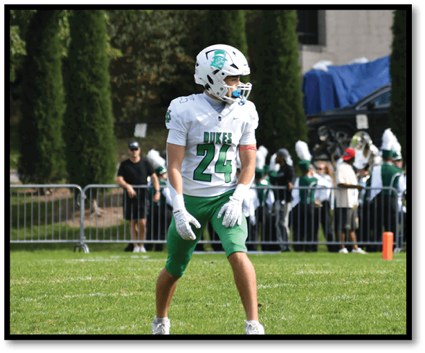 A football player is kicking a football on a field. Description generated by AI