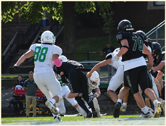 A football player is kicking a football on a field. Description generated by AI