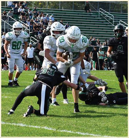 A football player wearing a black jersey with the number 11 on it. Description generated by AI
