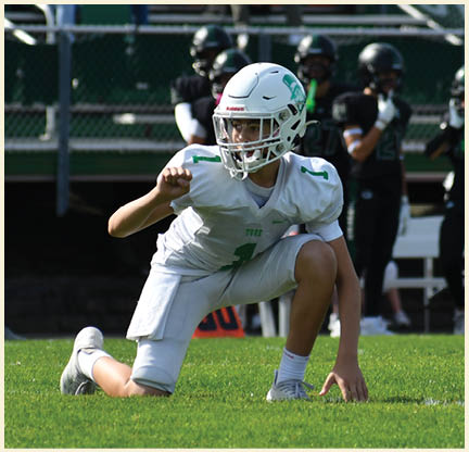 A football player wearing a black jersey with the number 11 on it. Description generated by AI
