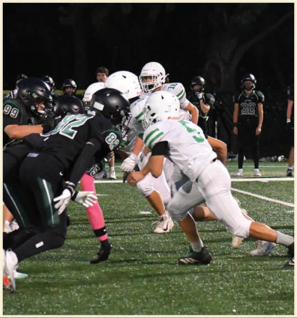 A football player wearing a black jersey with the number 11 on it. Description generated by AI