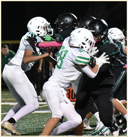 A football player wearing a black jersey with the number 11 on it. Description generated by AI