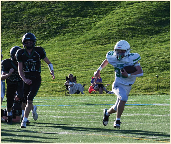 A football player is kicking a football on a field. Description generated by AI