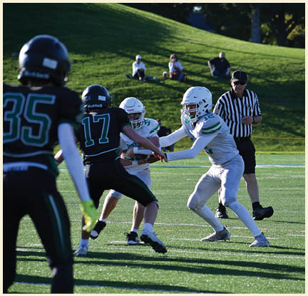 A football player wearing a black jersey with the number 11 on it. Description generated by AI