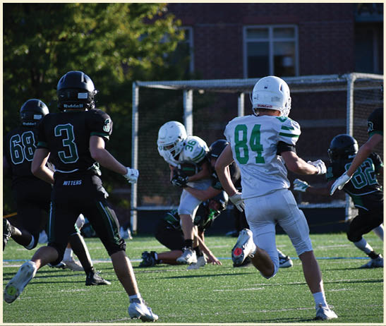 A football player is kicking a football on a field. Description generated by AI