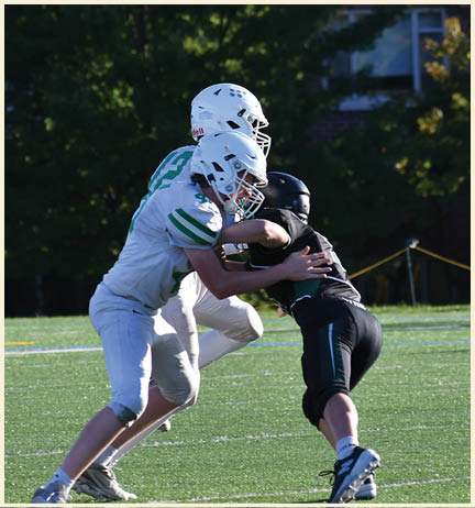 A football player wearing a black jersey with the number 11 on it. Description generated by AI