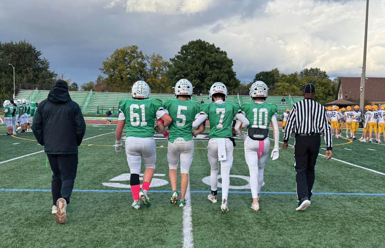 A group of people wearing black and white uniforms. Description generated by AI