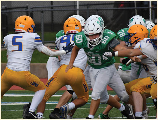 A football player is kicking a football on a field. Description generated by AI
