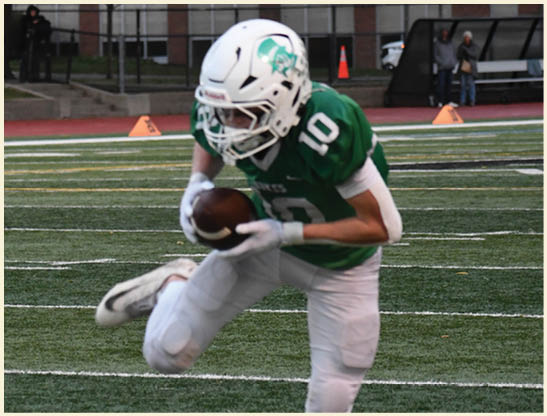 A football player is kicking a football on a field. Description generated by AI
