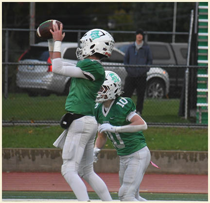A football player wearing a black jersey with the number 11 on it. Description generated by AI