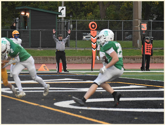A football player is kicking a football on a field. Description generated by AI