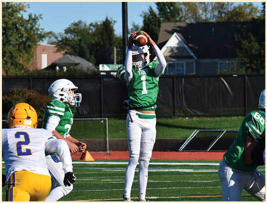 A football player is kicking a football on a field. Description generated by AI
