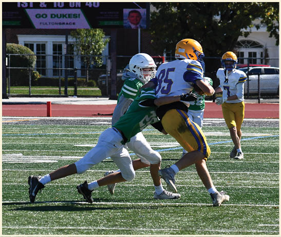 A football player is kicking a football on a field. Description generated by AI