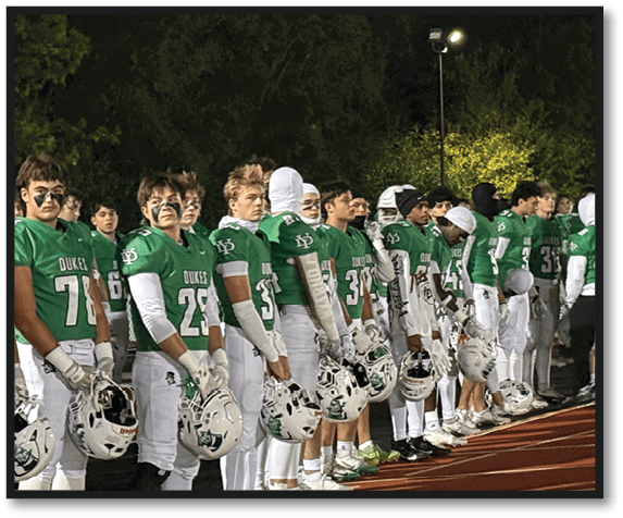 A group of football players wearing black jerseys with the number 3 on them. Description generated by AI