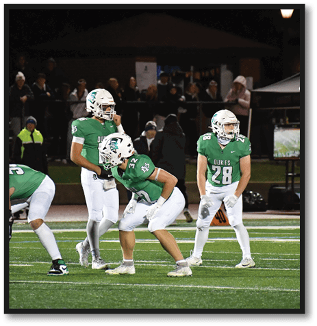 A football player wearing a black jersey with the number 6 on it. Description generated by AI