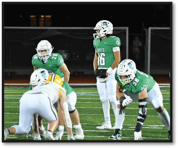 A group of football players wearing black jerseys with the number 3 on them. Description generated by AI