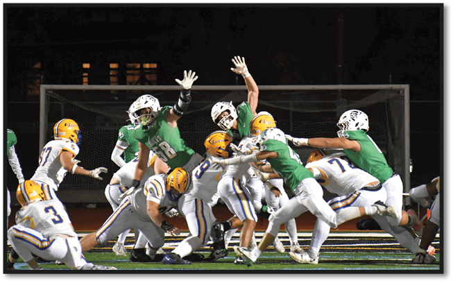 A football player wearing a black jersey with the number 6 on it. Description generated by AI