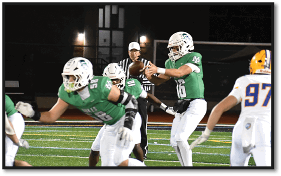 A group of football players wearing black jerseys with the number 3 on them. Description generated by AI