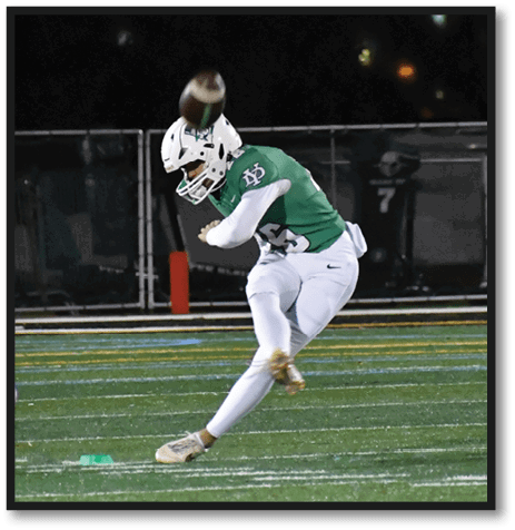 A football player wearing a black jersey with the number 6 on it. Description generated by AI
