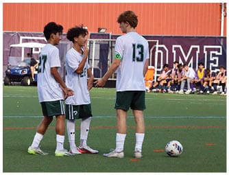 A group of football players on a field. Description generated by AI