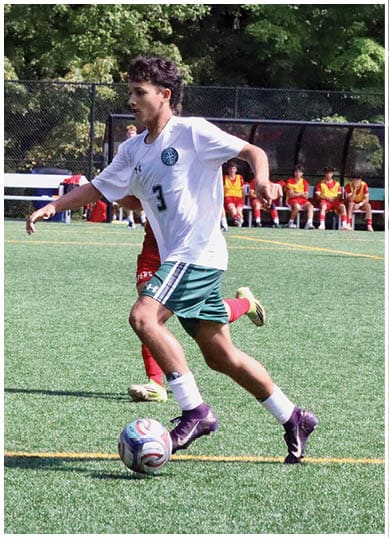 A football player wearing a blue and red jersey. Description generated by AI