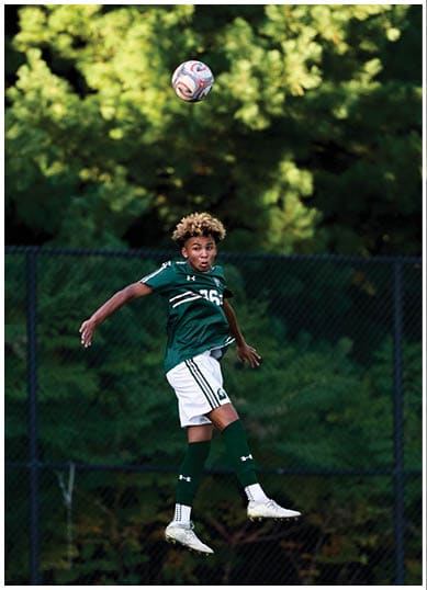 A football player wearing a blue and red jersey. Description generated by AI
