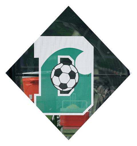 A football player wearing a black jersey with the number 10 sits on the ground with a football helmet on the ground next to him. AI generated content