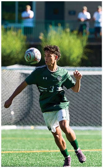 A football player catching a ball. Description generated by AI