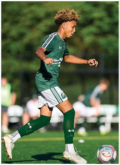 A football player wearing a blue and red jersey. Description generated by AI
