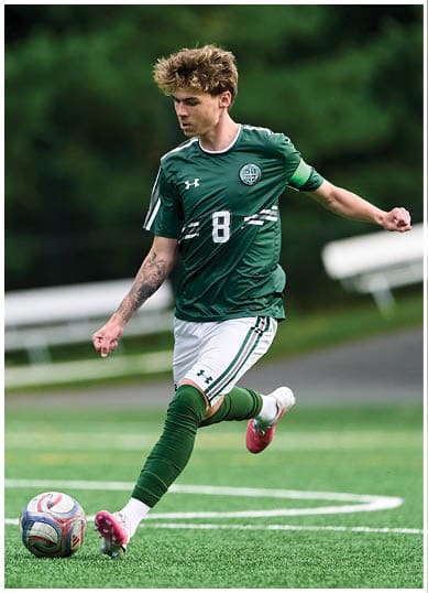 A football player wearing a blue and red jersey. Description generated by AI
