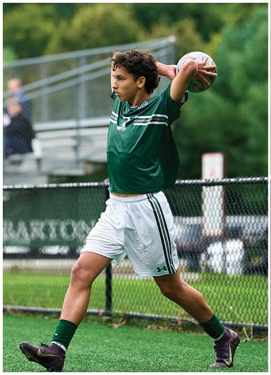 A football player wearing a blue and red jersey. Description generated by AI
