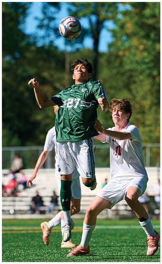 A football player catching a ball. Description generated by AI