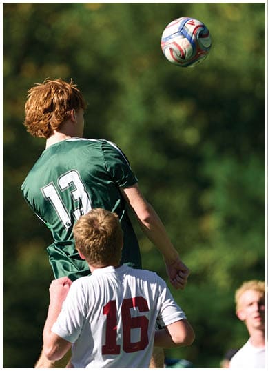 A football player wearing a blue and red jersey. Description generated by AI