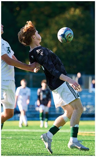 A football player catching a ball. Description generated by AI