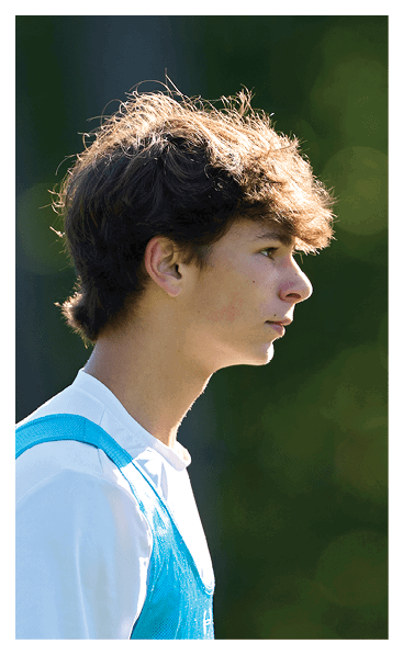 A young man wearing a football jersey with the name Vista on the back. AI generated content