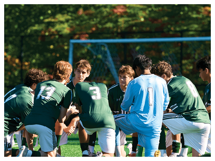 A group of football players on a field, one of them is running with a football. AI generated content