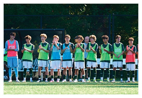 A group of people are kneeling on a field, possibly in a football game. AI generated content