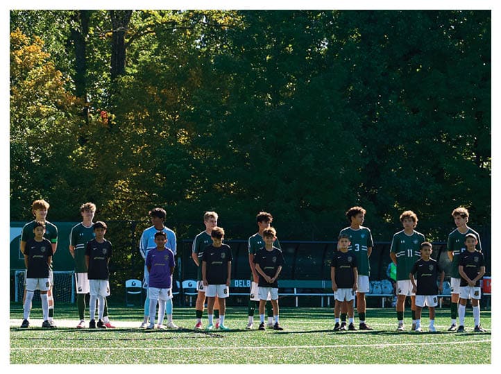A group of football players on a field, one of them is running with a football. AI generated content