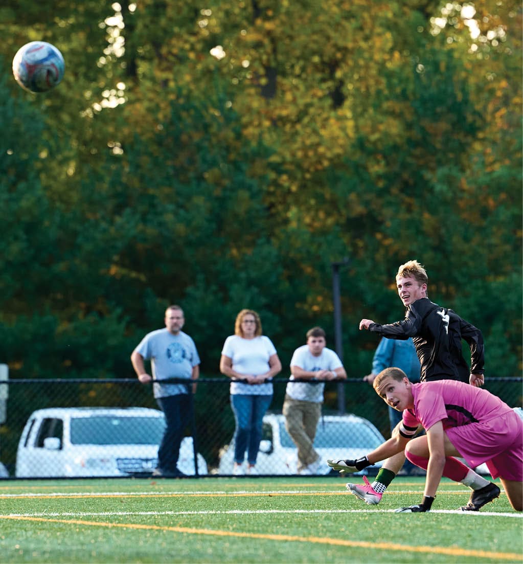 A football player running with a football. Description generated by AI