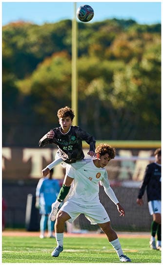 A football player catching a ball. Description generated by AI