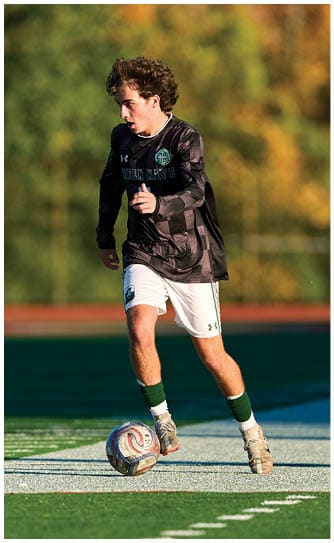 A football player catching a ball. Description generated by AI