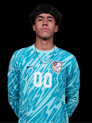 A young man wearing a white and black jersey with the number 14 on it. Description generated by AI