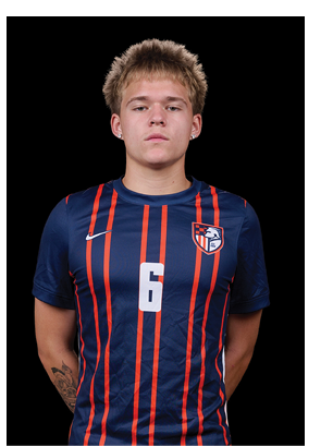 A young man wearing a white and black jersey with the number 14 on it. Description generated by AI