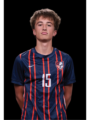 A young man wearing a white and black jersey with the number 14 on it. Description generated by AI