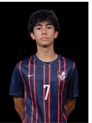 A young man wearing a white and black jersey with the number 14 on it. Description generated by AI
