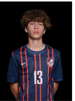 A young man wearing a white and black jersey with the number 14 on it. Description generated by AI