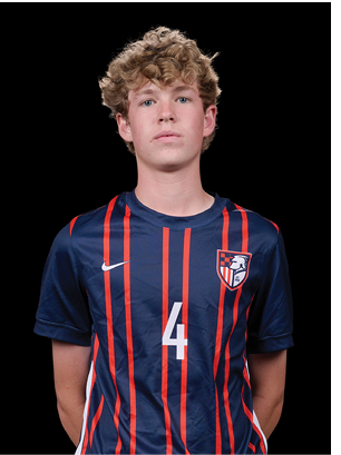 A young man wearing a white and black jersey with the number 14 on it. Description generated by AI