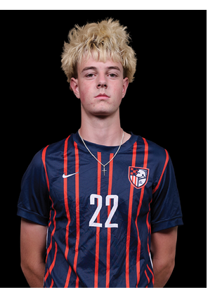 A young man wearing a white and black jersey with the number 14 on it. Description generated by AI